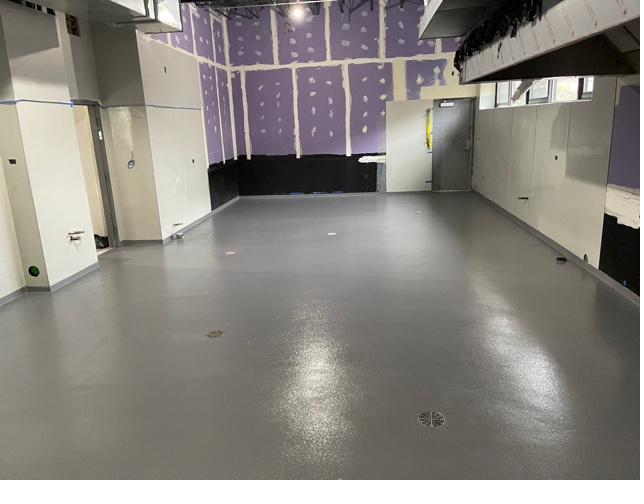 Grey epoxy floor coating in a new construction dining room in Wisconsin
