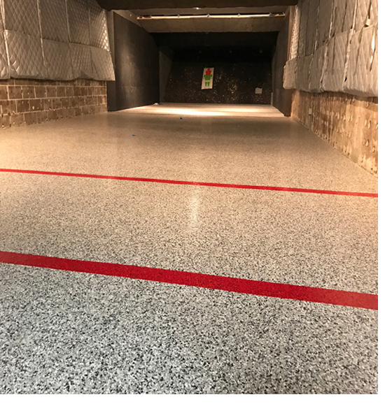 Grey quartz flake epoxy floor in a Wisconsin indoor shooting range